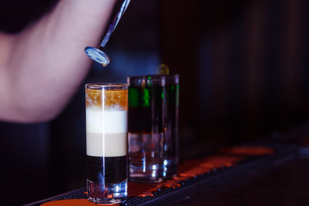 preparation of a shot cocktail at the bar counterの写真素材