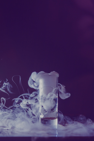 beautiful smoke from a glass with reflectionの写真素材