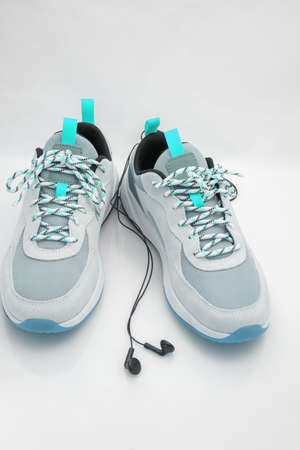 sports sneakers with headphones on white