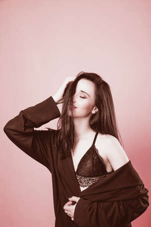 portrait of attractive sexy girl on a gentle pink backgroundの写真素材