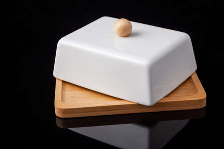 a set of porcelain and wooden utensils, on a black background.の写真素材