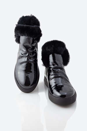 Comfortable patent leather boots. On a white backgroundの写真素材