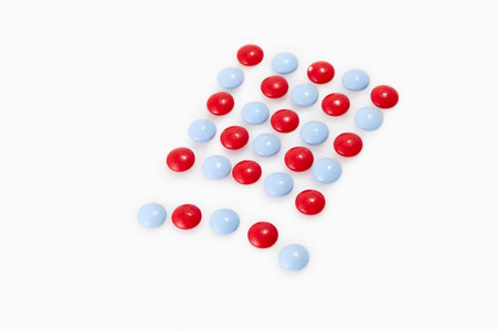 blue and red pills on white backgroundの写真素材