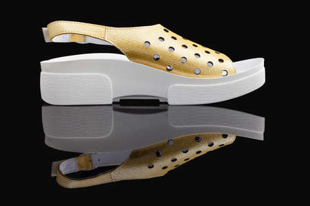yellow, stylish, comfortable, women's sandals on a black backgroundの写真素材