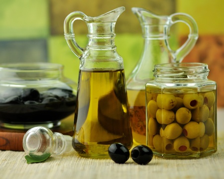  bottles of olive oil with black and green olivesの写真素材