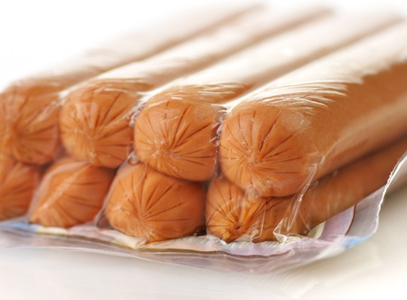 sausages in a plastic package on a white background, closeupの写真素材