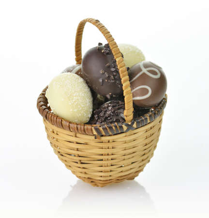 assortment of chocolate eggs in a basketの写真素材