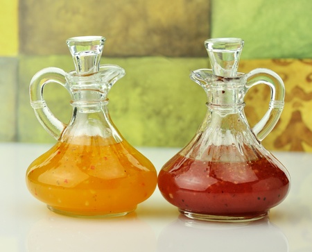 italian  and raspberry vinaigrette salad dressings in glass bottles