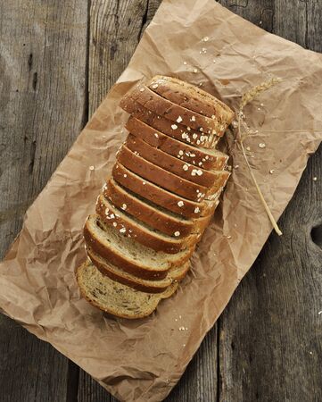 Sliced Brown Wholewheat Bread On A Wooden Surface
