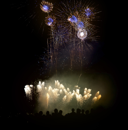 Silhouettes Of People Watching Beautiful Fireworksの写真素材
