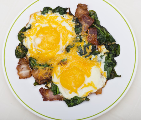 Keto diet breakfast with  eggs, spinach and bacon.Low carb high fat breakfast.の写真素材