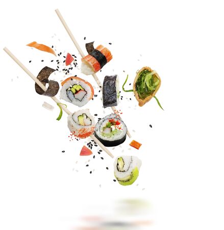 sushi rolls and ingredients with wooden chopsticks isolated on white backgroundの写真素材