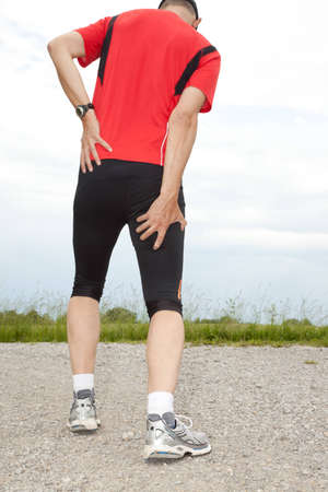 A runner holding his thigh