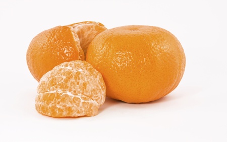 Mandarin fruits (peeled and unpeeled) isolated on white backgroundの写真素材