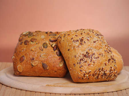 Bread and rolls on a cherry wood tableの写真素材
