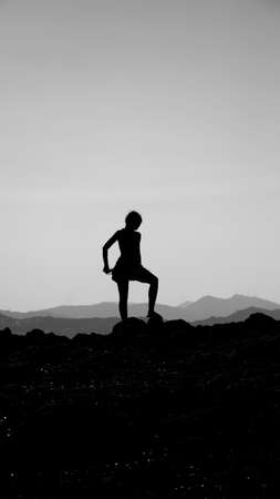 silhouette of a young woman on an endless horizon