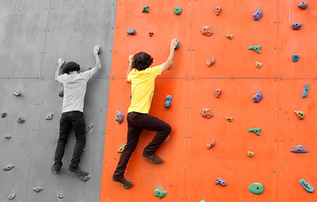 suit businessman climbs over the orange wallの写真素材