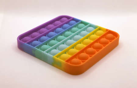 Rainbow colored pop it toys isolated white backgroundの写真素材