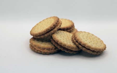 Group shoot of stacked biscuits isolated white backgroundの写真素材