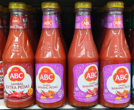 Jakarta, Indonesia-July 6, 2021: Close up of a row of abc chili sauce bottles on a supermarket shelfの写真素材