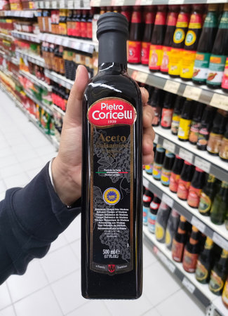 Jakarta, Indonesia-July 6, 2021: close up of hands holding pietro coricelli with products on a supermarket shelfのeditorial素材