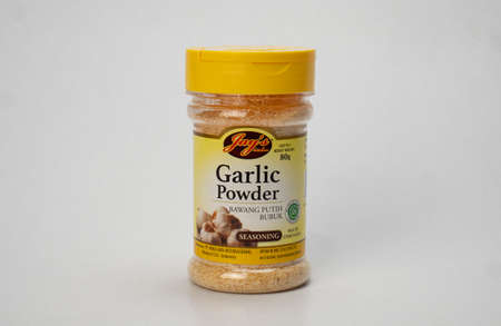 Jakarta, Indonesia: August 1, 2021: Bottle of garlic powder isolated white background, copy spaceのeditorial素材