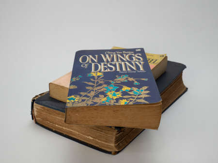 Jakarta, Indonesia-August 2, 2021: Pile of old books isolated white background