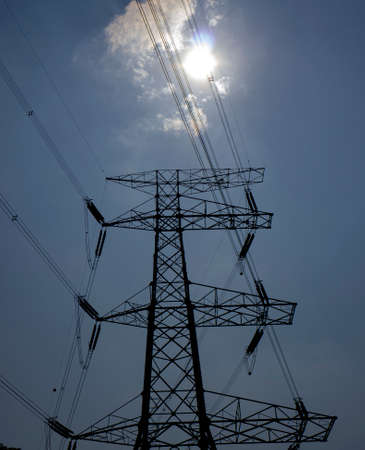 Low angle view of high voltage Tower or electricity tower on sky backgroundの写真素材