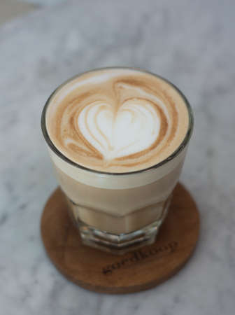 a glass of hazelnut latte on a ceramic table