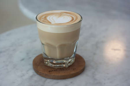 a glass of hazelnut latte on a ceramic table