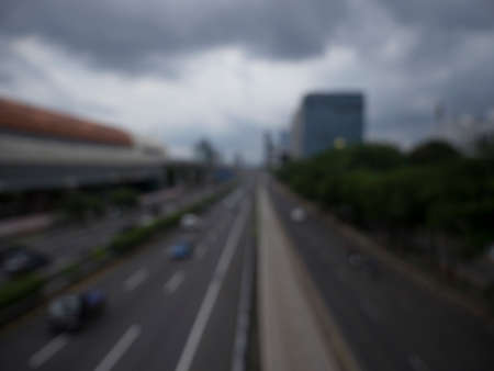Abstract blurred highway with city downtown backgroundの写真素材