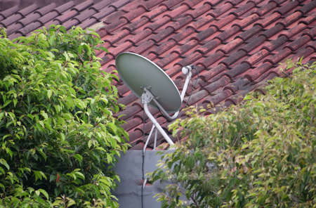 Satellite Dish on the roof of the houseの写真素材