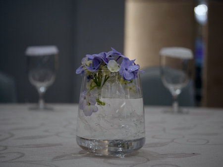 flowers in a glass vase on a table in a restaurantの写真素材