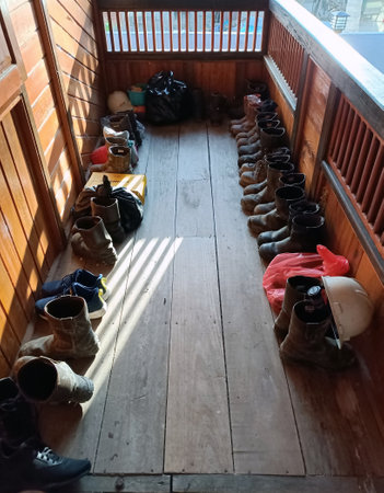 Old shoes in a row on the floor of a wooden house.の写真素材