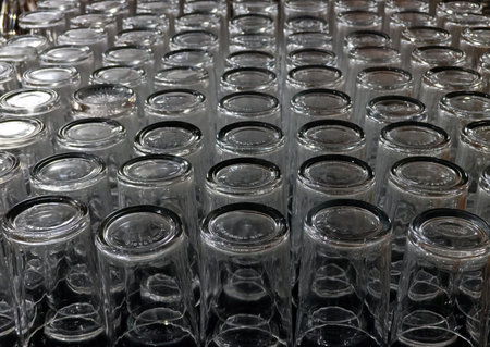 Close up shot of a row of empty transparent glass bottles in a rowの写真素材