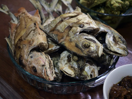 Fried fish in a glass bowl on a wooden table. Close up.の写真素材