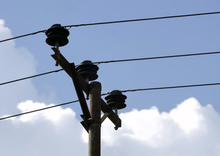 Electricity post with blue sky and white clouds. Selective focus.の写真素材