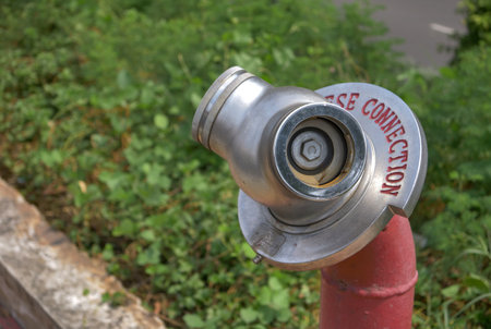 Coin-operated binoculars on a red fire hydrant.の写真素材