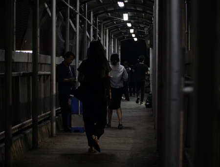 People walking in a tunnel at night.の写真素材