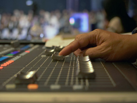 Mixing console in a night club, close-up of hands