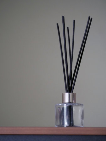 Aromatic reed air freshener bottle on a tableの写真素材