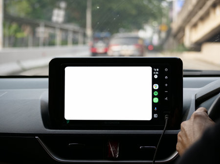 Close-up of smart phone with blank screen on steering wheel.の写真素材