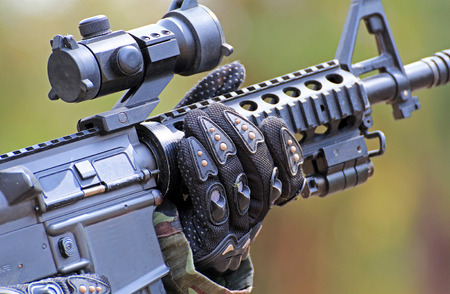 A man in soldier suit with BB gun