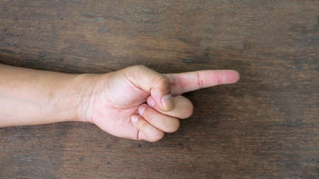Hand symbolizing used in every day on wood backgroundの写真素材