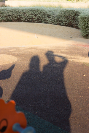 Shadows of Twins people Holding Hands in the garden,on floor