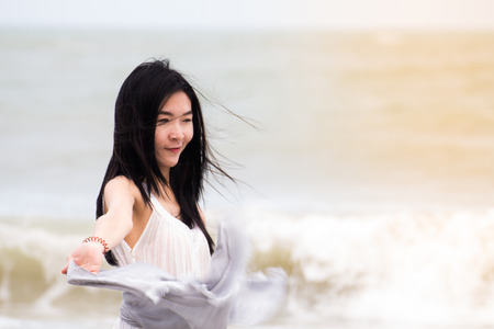 Portrait of beautiful young asian woman summer vacation on beach,Cute teenage girl at sea with scarfの写真素材