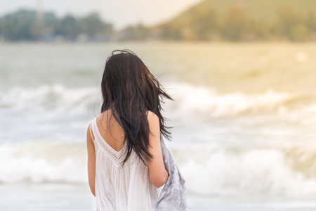Portrait of beautiful young asian woman summer vacation on beach,Cute teenage girl at sea with scarfの写真素材