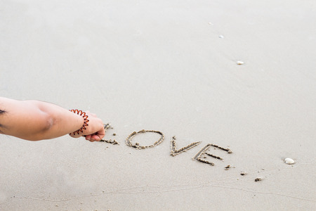 Write the word love letters on the sand,feelingの写真素材