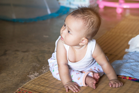 Little girl sitting on floor in her houseの写真素材