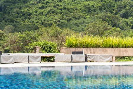 Beautiful corner of the garden and pool in glof club with forest and mist background,decoration gardeningのeditorial素材